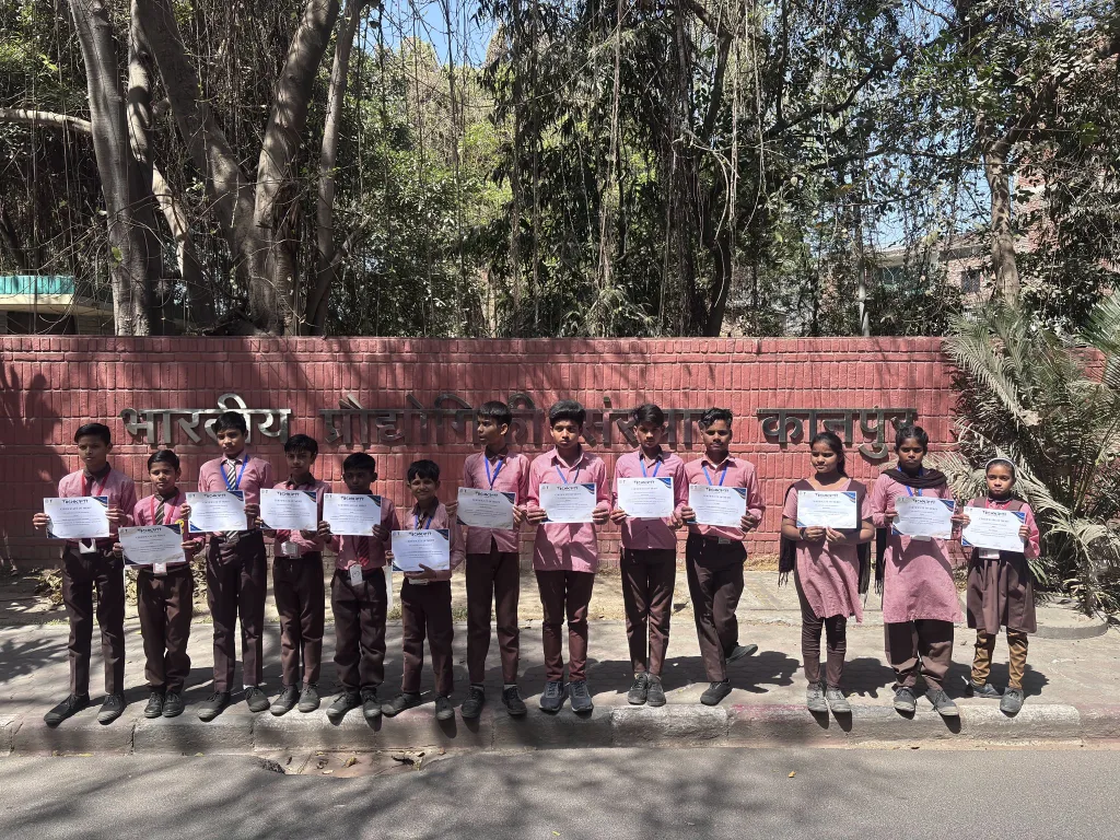 Sambhal's government school kids at IIT Kanpur with their certificate of outstanding performance in national level robotics competition at Techkriti 2025