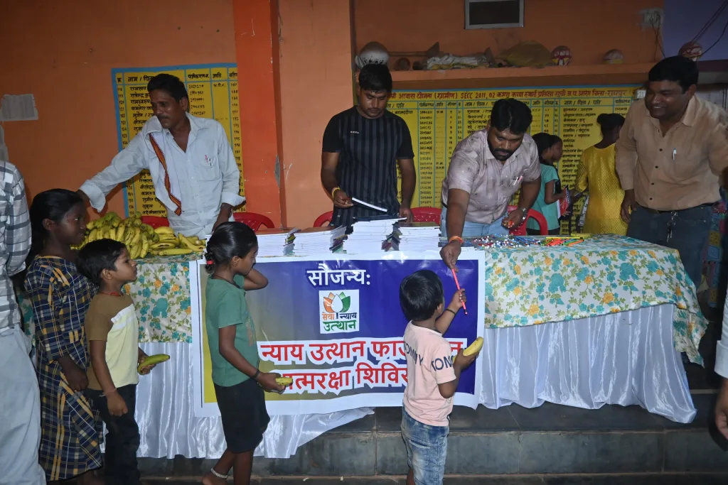 Kids receiving stationery items in the camp organised by Sewa Nyaya Utthan Foundation