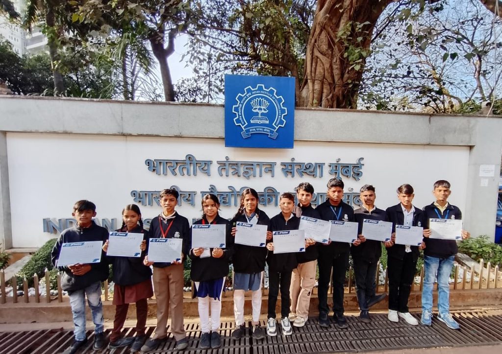 Government school students from Sambhal holding Certificates of Excellence outside the Indian Institute of Technology Bombay after competing at Techfest 2025